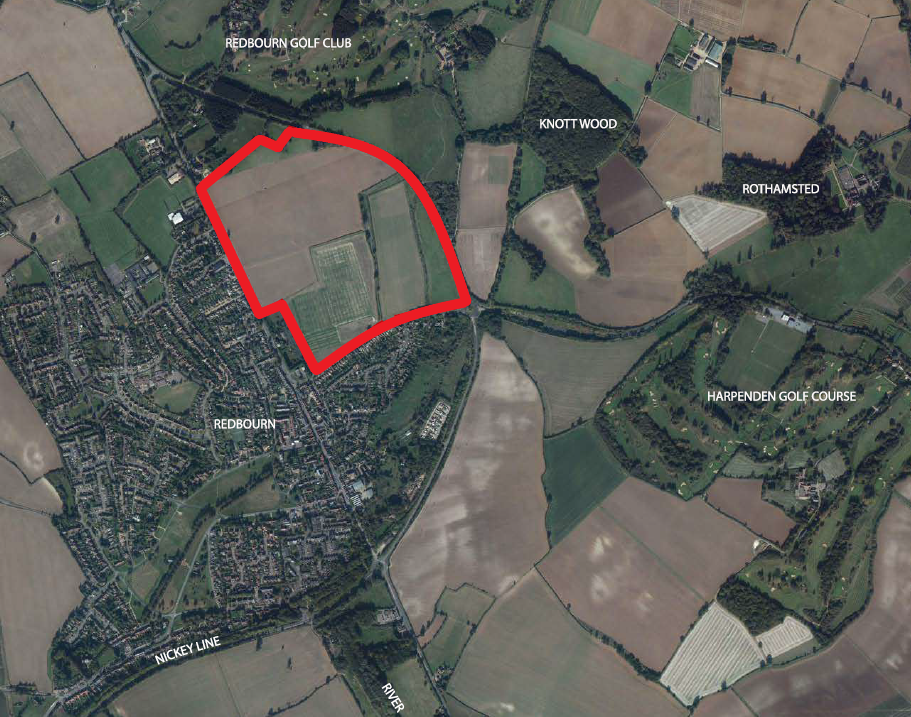 Illustrated map showing grid pattern of grey rectangular buildings on green background with darker green wooded areas and water features.