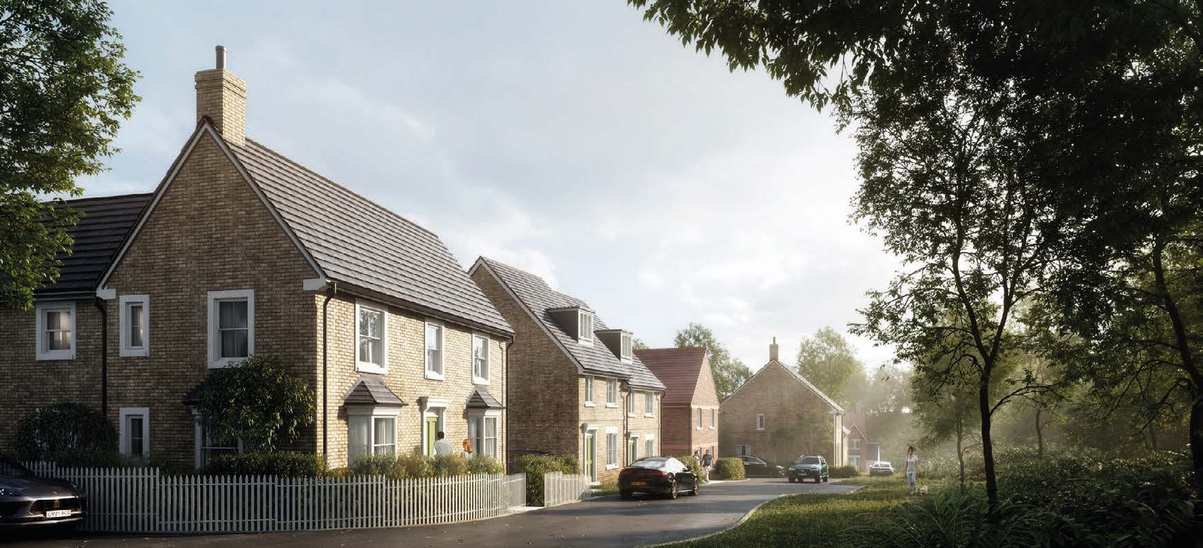 Row of modern houses with beige brick facades and dark roofs along tree-lined street under cloudy sky.